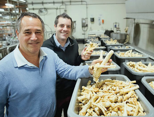 Domonic and Jeffrey Biggi holding horseradish roots